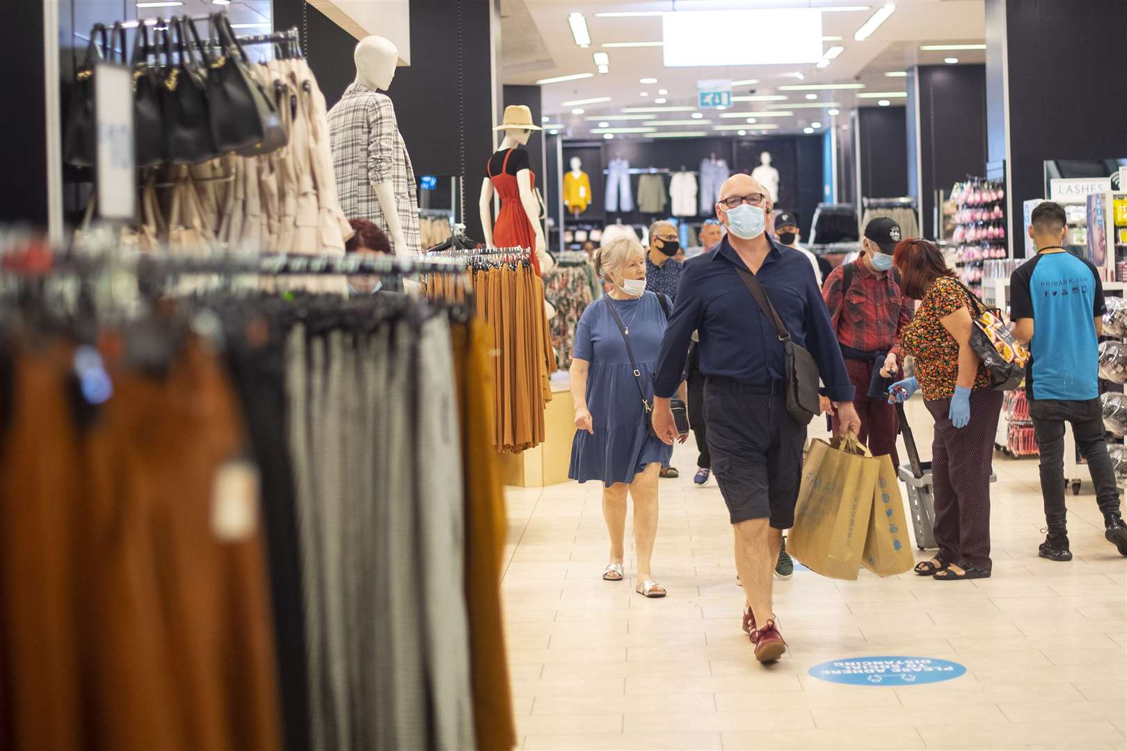 Customers wear face masks as they shop inside Primark in Oxford Street, London (PA)