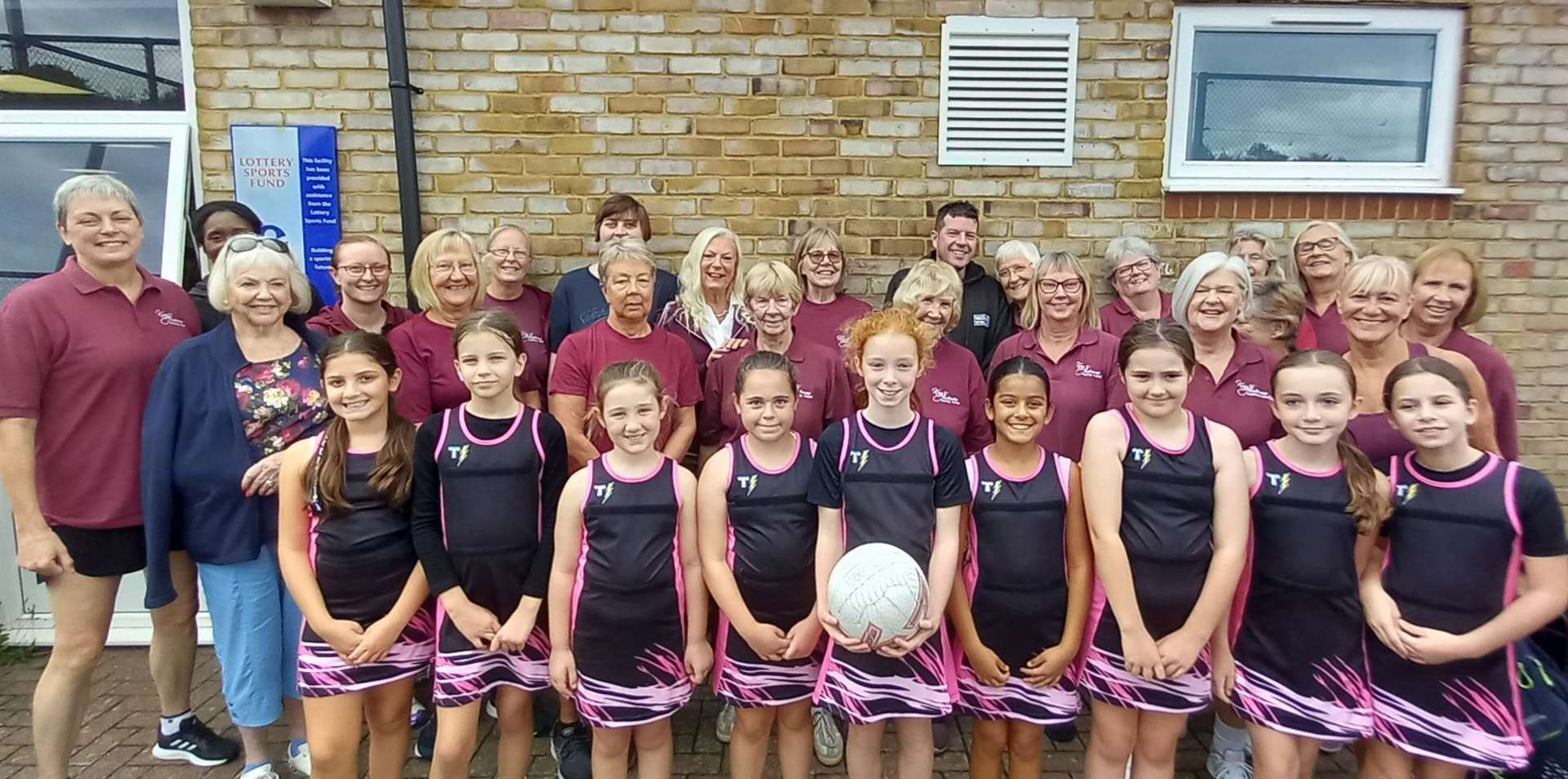 Former MNL players, who now play walking netball at King's Rochester Sports Centre, are pictured with a new generation of players, Pink Crystals, who play in Division 2 and are all about 10 years old