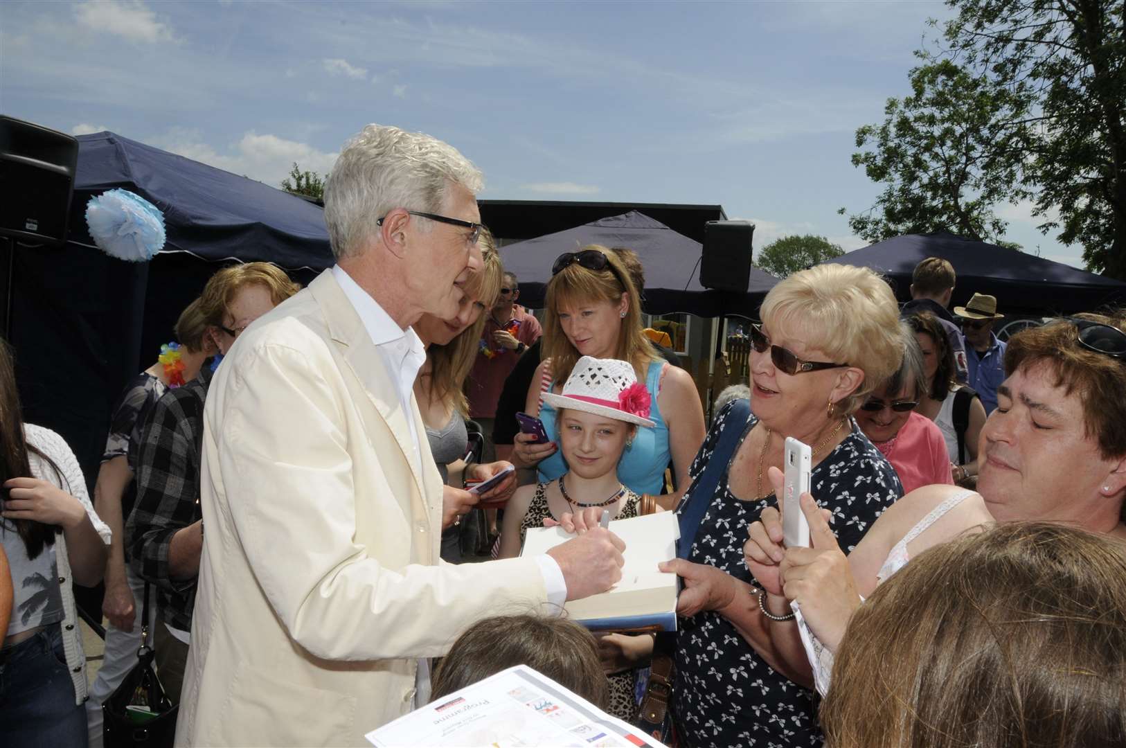 Paul O'Grady signs autographs after opening a fête close to his Kent home