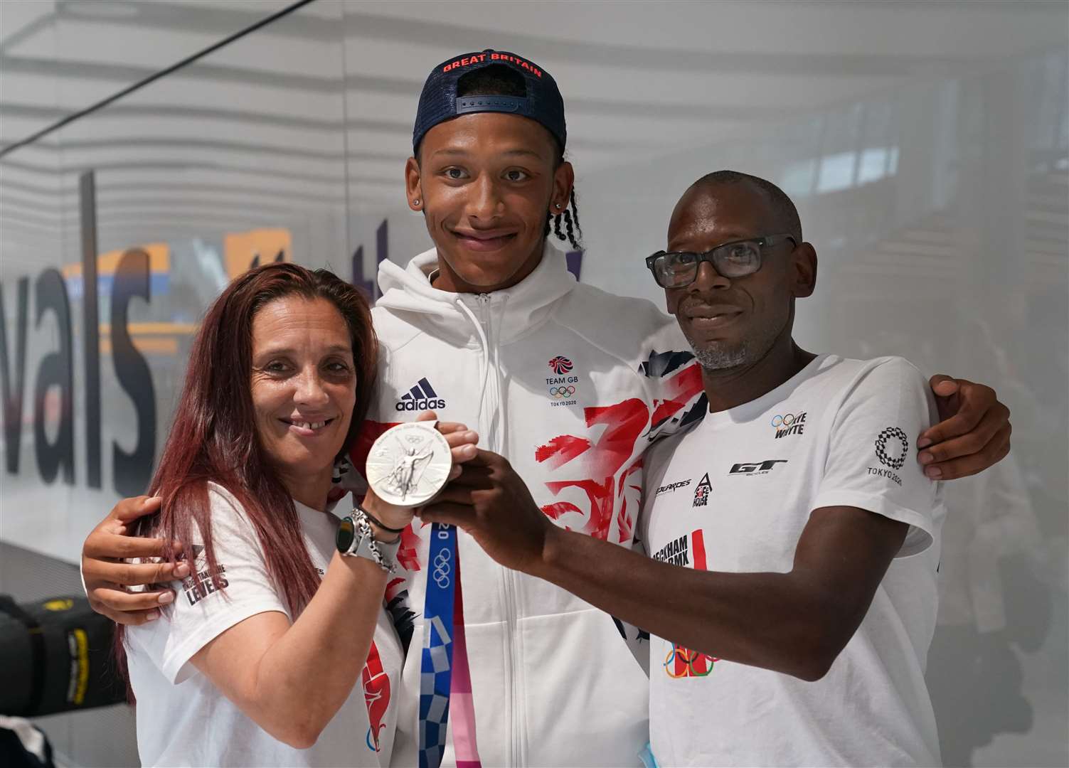 Kye Whyte at Heathrow Airport with his parents Nigel and Tracey (Steve Parsons/PA)