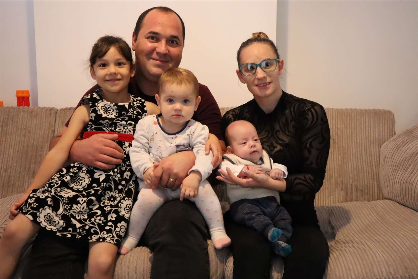 The Dutuc family at home in Castle Street, Queenborough. From the left: Anna-Jarla, 5, dad Alexandru, Anna-Karina, 16 months, baby Alexandru-Loachim and mum Eliza