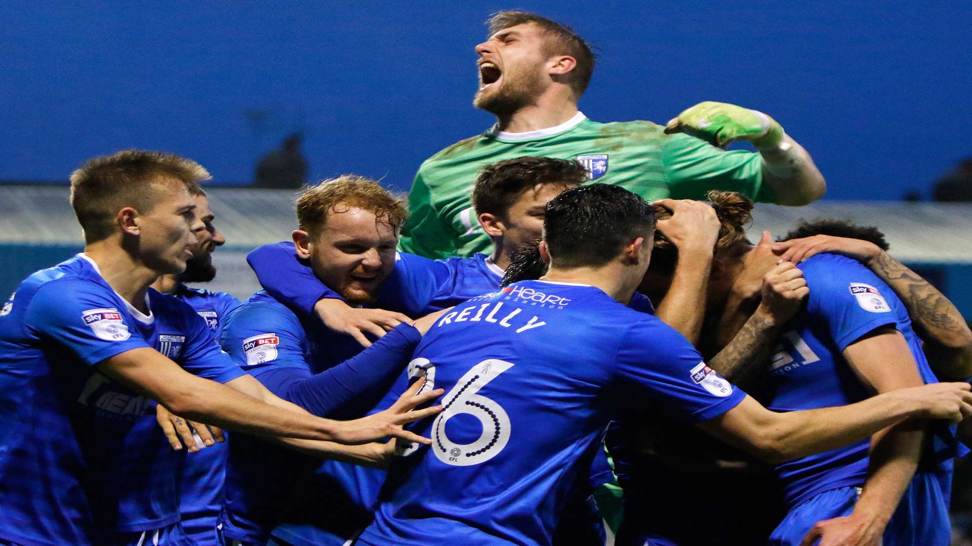 Tom Eaves is mobbed by his team-mates after his injury-time winner from the spot Picture: Andy Jones