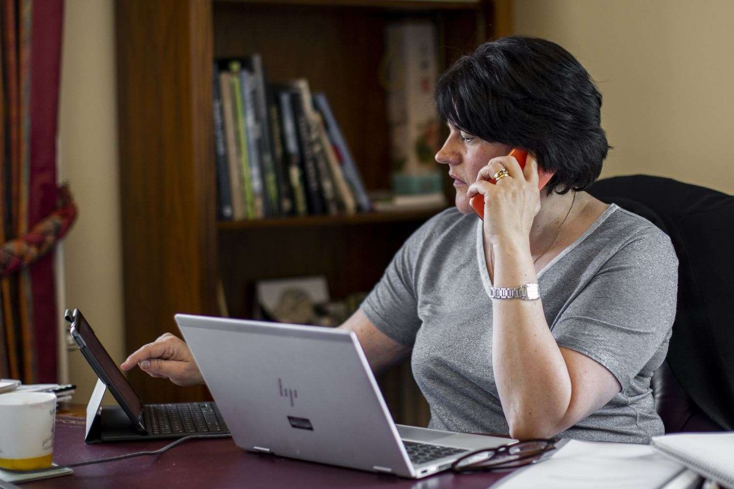 Arlene Foster takes a call in her Stormont Castle office (Liam McBurney/PA)