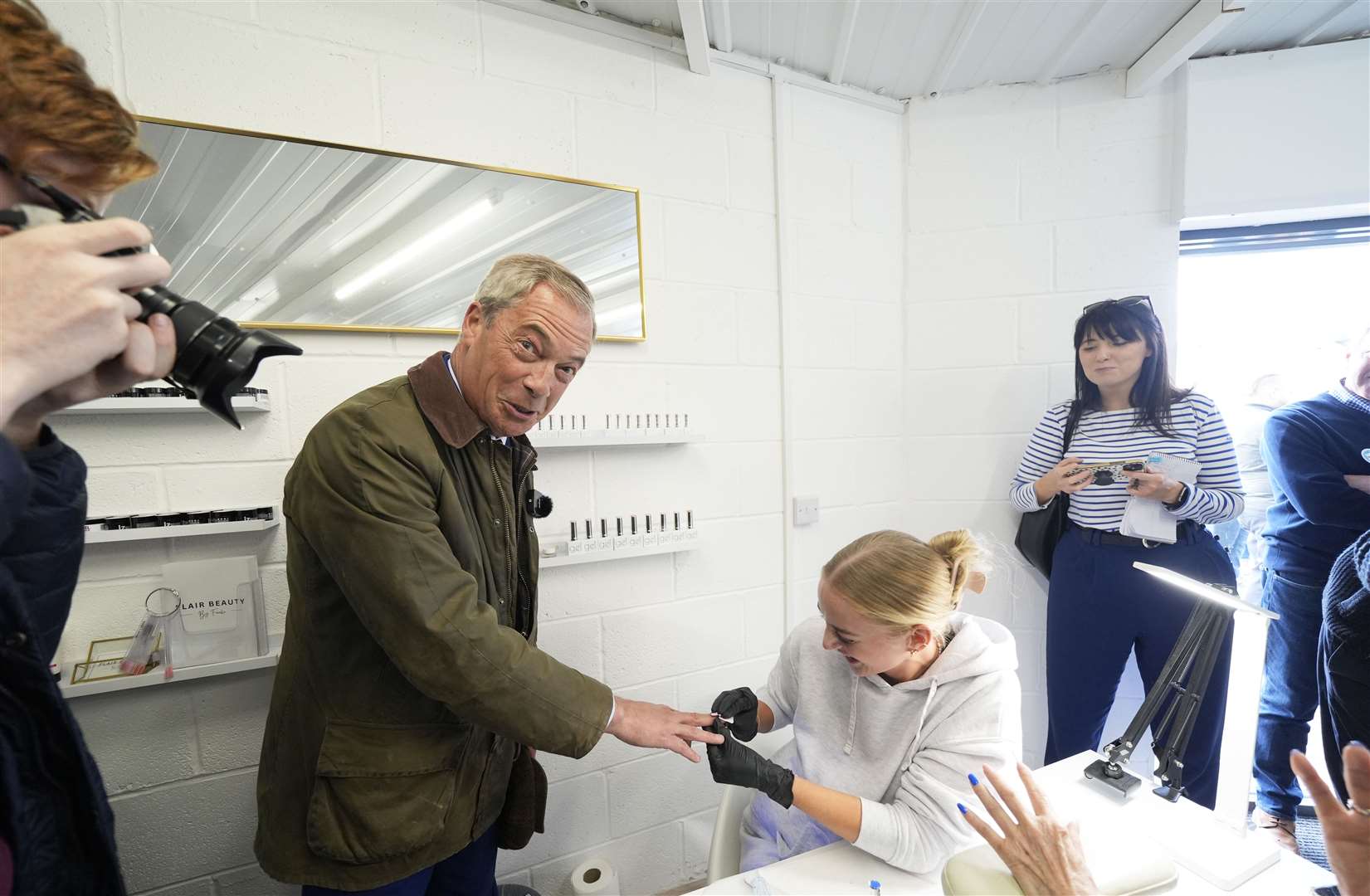 Earlier, Mr Farage had a nail painted when he stopped at On The Lash beauty salon, in Hoyland (Danny Lawson/PA)