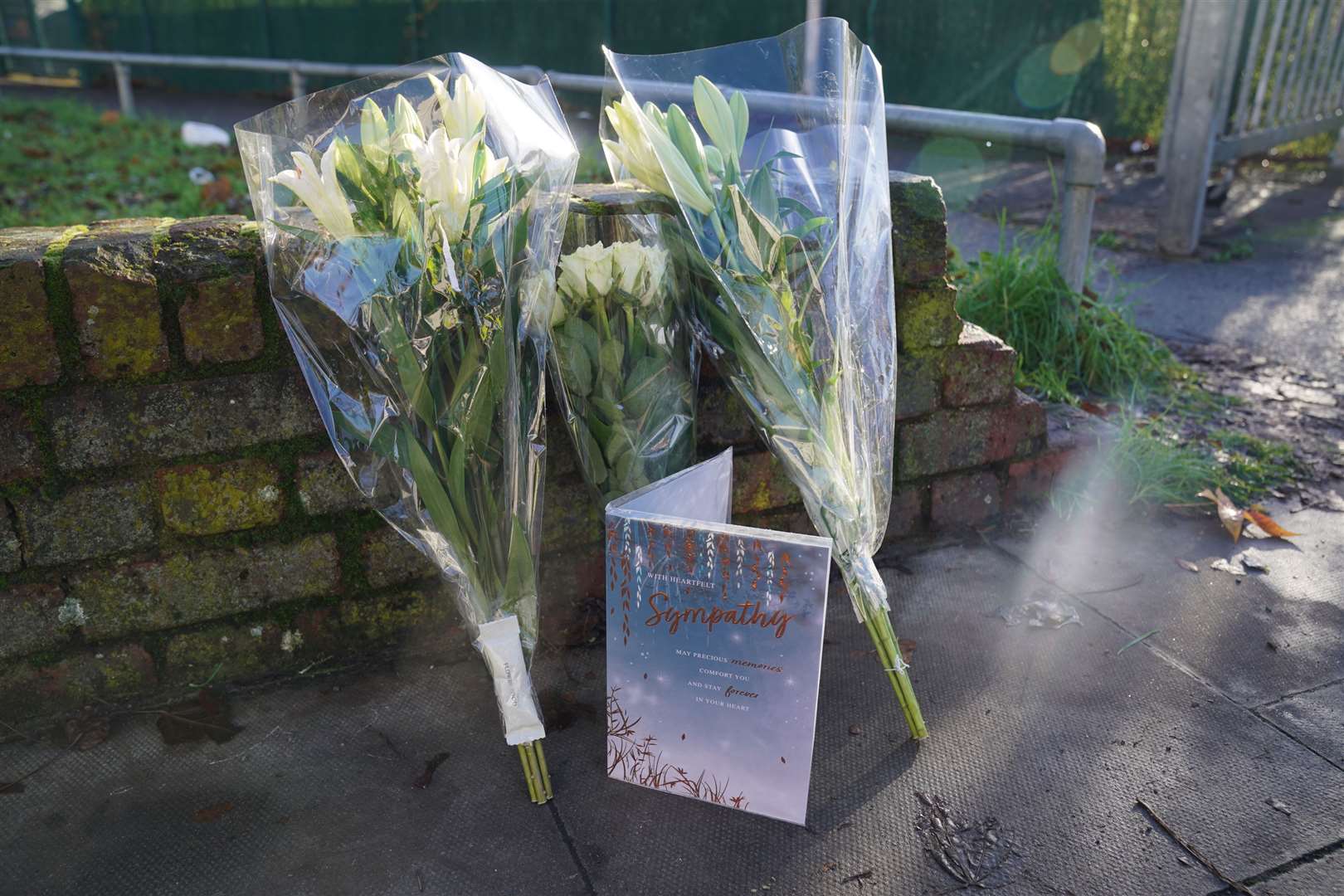 A card and flowers left near the scene (Lucy North/PA)