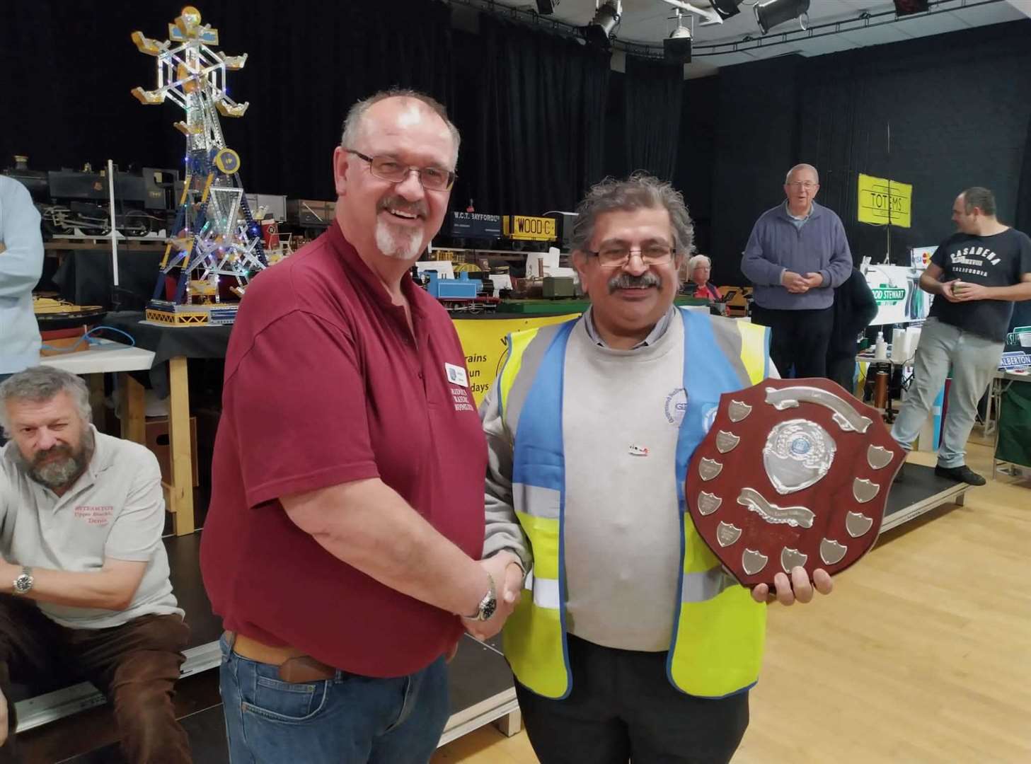 Andrew Town, owner of the Lenham station layout, is presented with his winner’s trophy by George Marcar. Picture: GRES