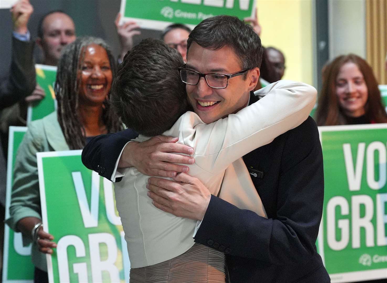 Green Party co-leaders Carla Denyer and Adrian Ramsay share a hug during the Green Party General Election campaign launch at St George’s in Bristol (Jonathan Brady/PA)