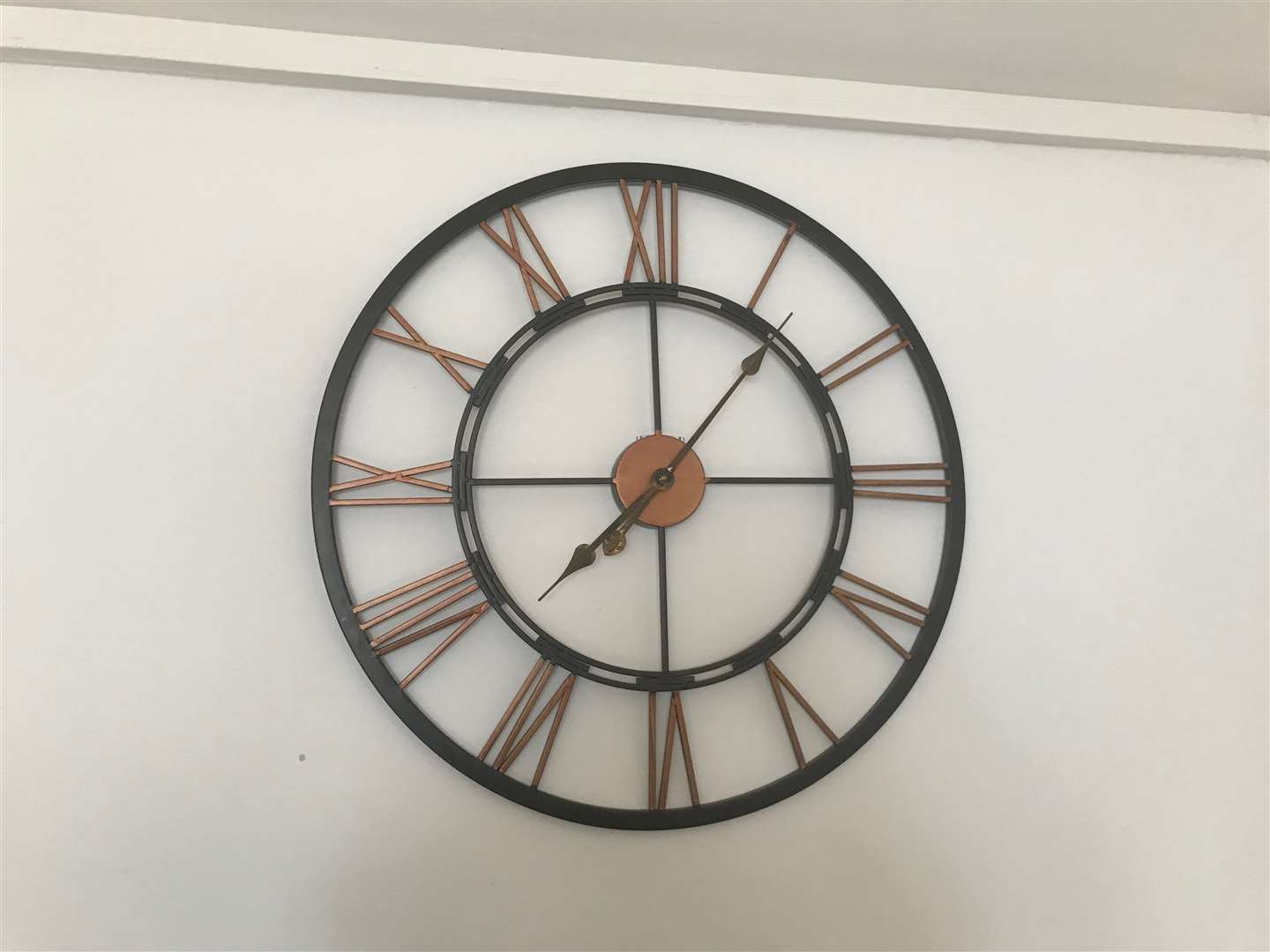 The clock on the wall, permanently stuck at seven minutes past seven