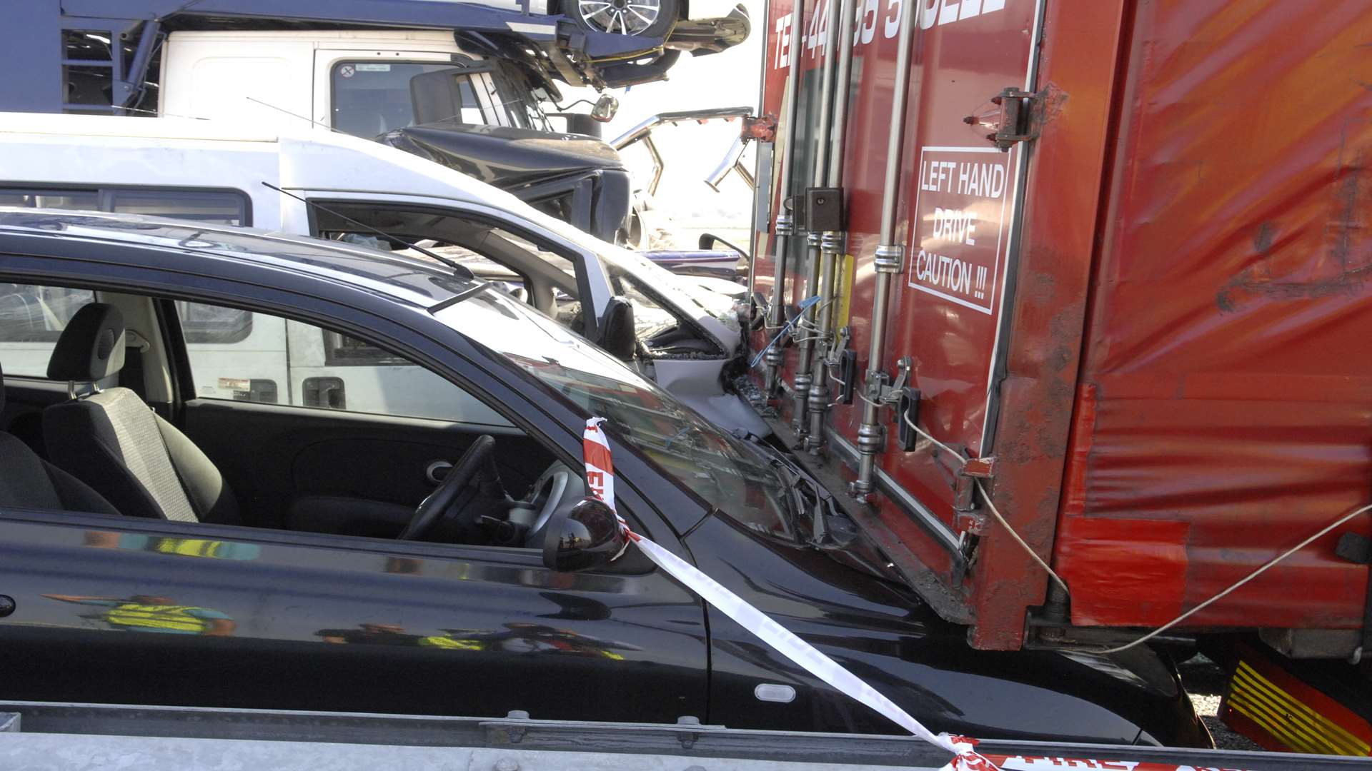 A car left wedged under a lorry. Picture: Chris Davey