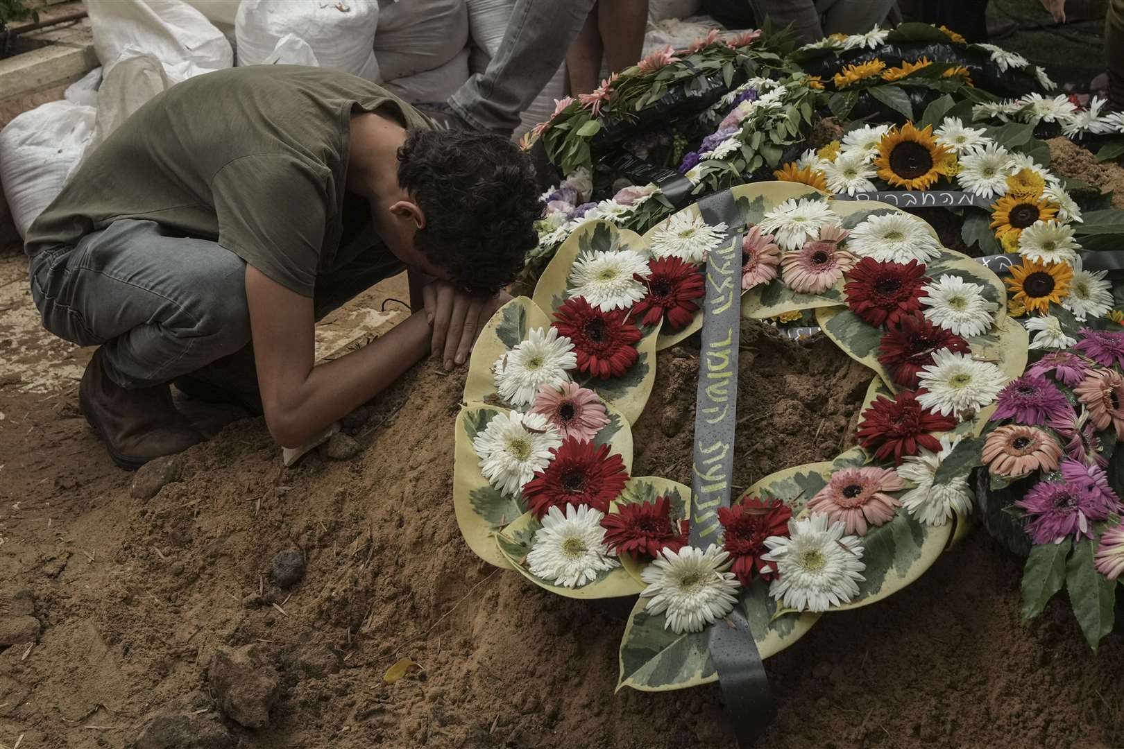 A man mourns during the funeral of Israeli Colonel Roi Levy at the Mount Herzl cemetery in Jerusalem on Monday (Maya Alleruzzo/AP)