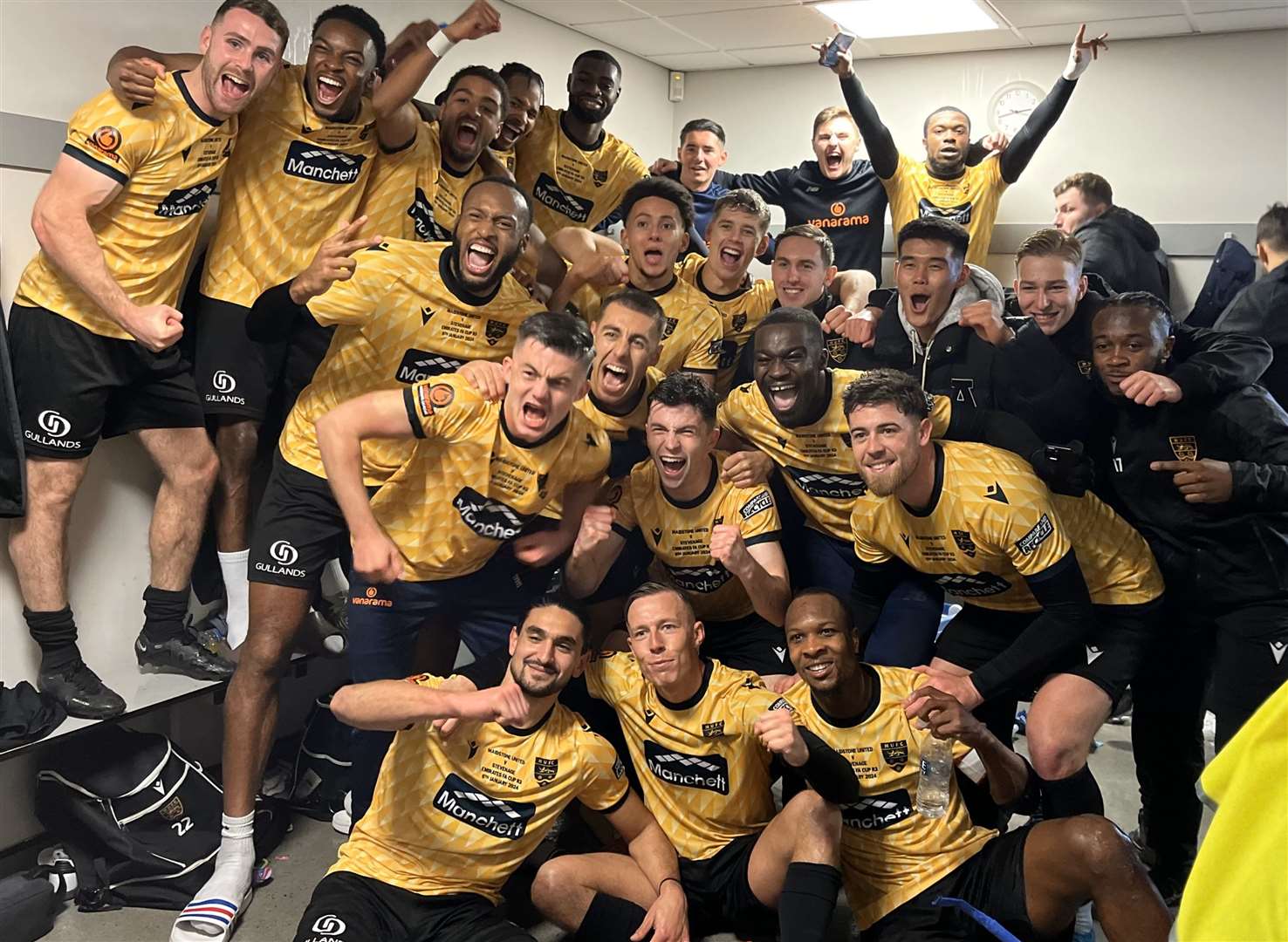 Maidstone United players celebrate in the dressing room after beating Stevenage. Picture: Steve Terrell