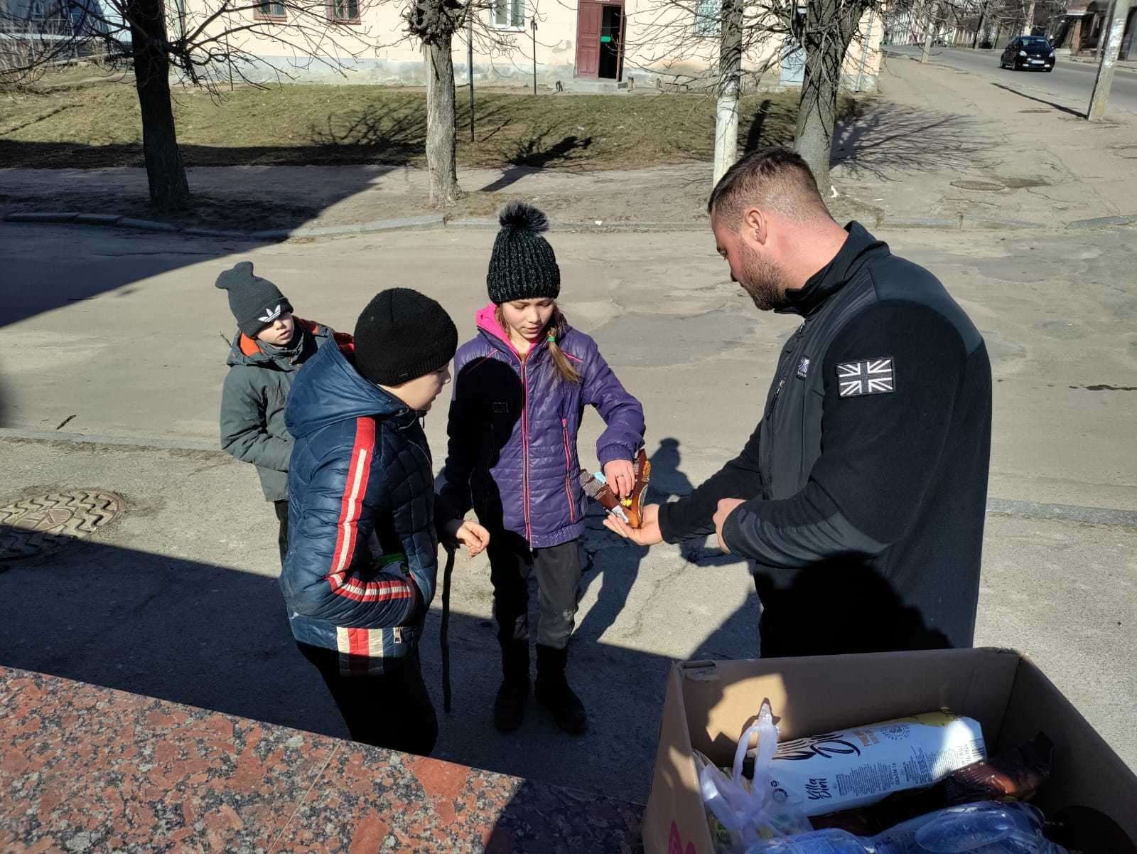 Matt Spedding handing out supplies to children in Ukraine