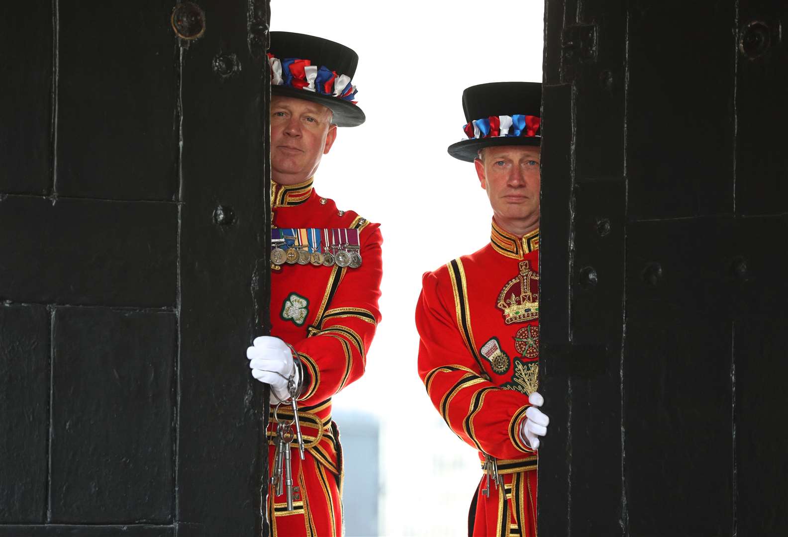 Yeoman Warder Darren Hardy and Yeoman Serjeant Clive Towell open the West Door at the Tower of London (Jonathan Brady/PA)