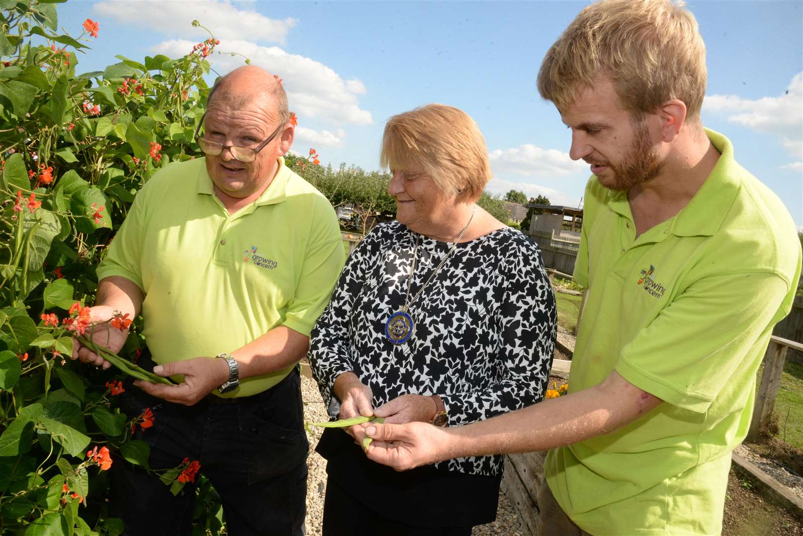 Clients Andrew Evans and Graham Hepburn show Deputy mayor Cllr Marion Ring the runner beans