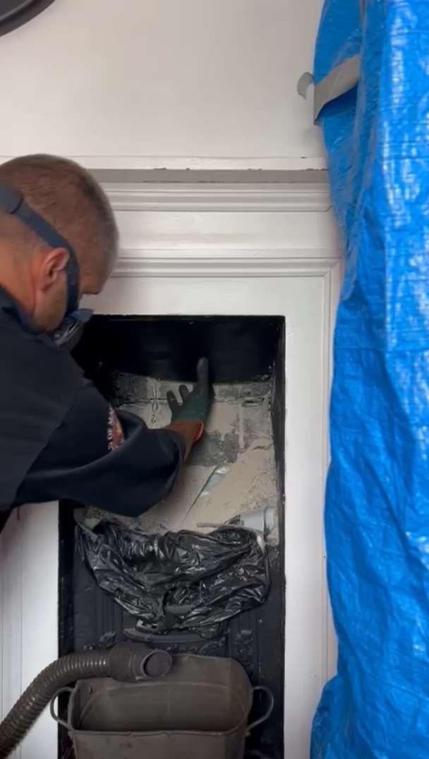 Neil Jarrett tentatively pulled down a board within a chimney sweep before revealing a trapped seagull (Neil Jarrett)