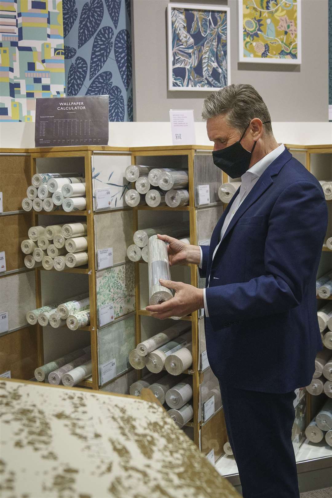 Labour Party leader Sir Keir Starmer browses through the wallpaper section at John Lewis & Partners department store at the Intu Trafford Centre (Christopher Furlong/PA)