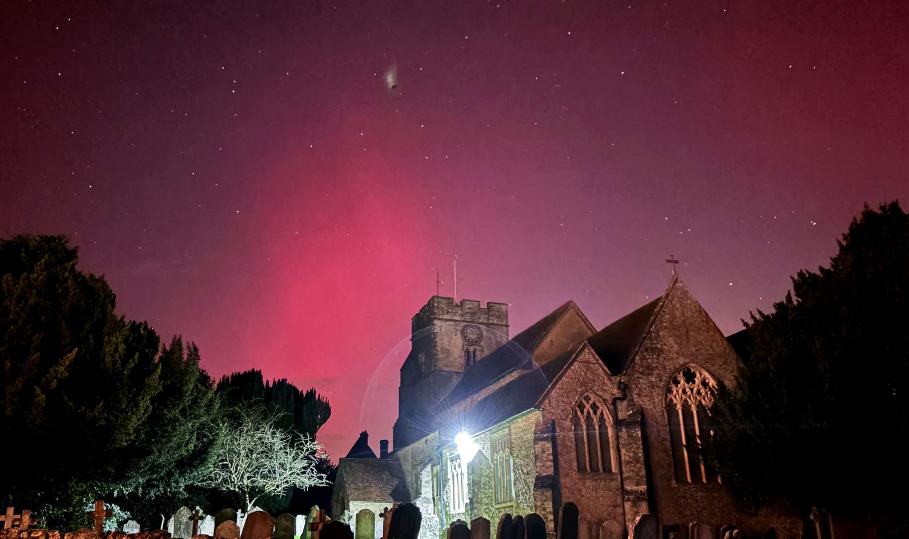 An eye-catching display above Great Chart Church in Ashford, Kent – showcasing how far south the aurora was visible (Gareth Fuller/PA)