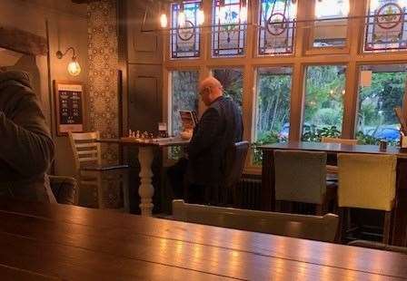 Checkmate - a couple of chaps sitting in front of the impressive stained glass windows were enjoying a game of chess