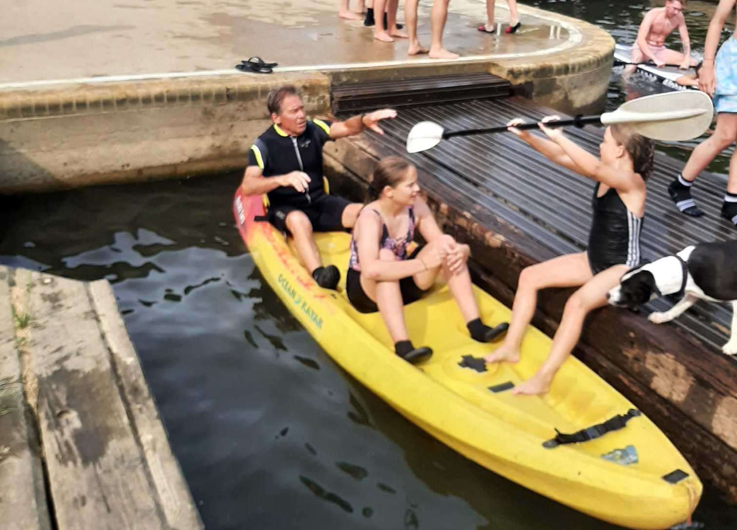 Paul at the back of the kayak getting on with his grandchildren. Picture: Paul Gill