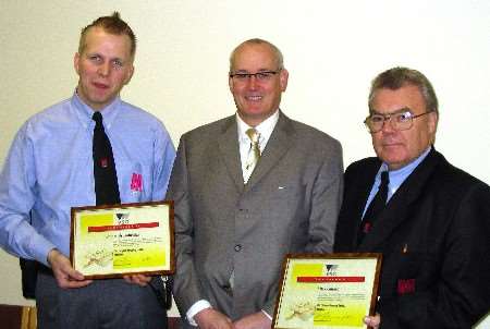 Stuart Brumbridge (left) and Mick Gillard (right) receive certificates of thanks from Vision Security Group managing director Bill Muskin. Picture: GINNIE ORAM