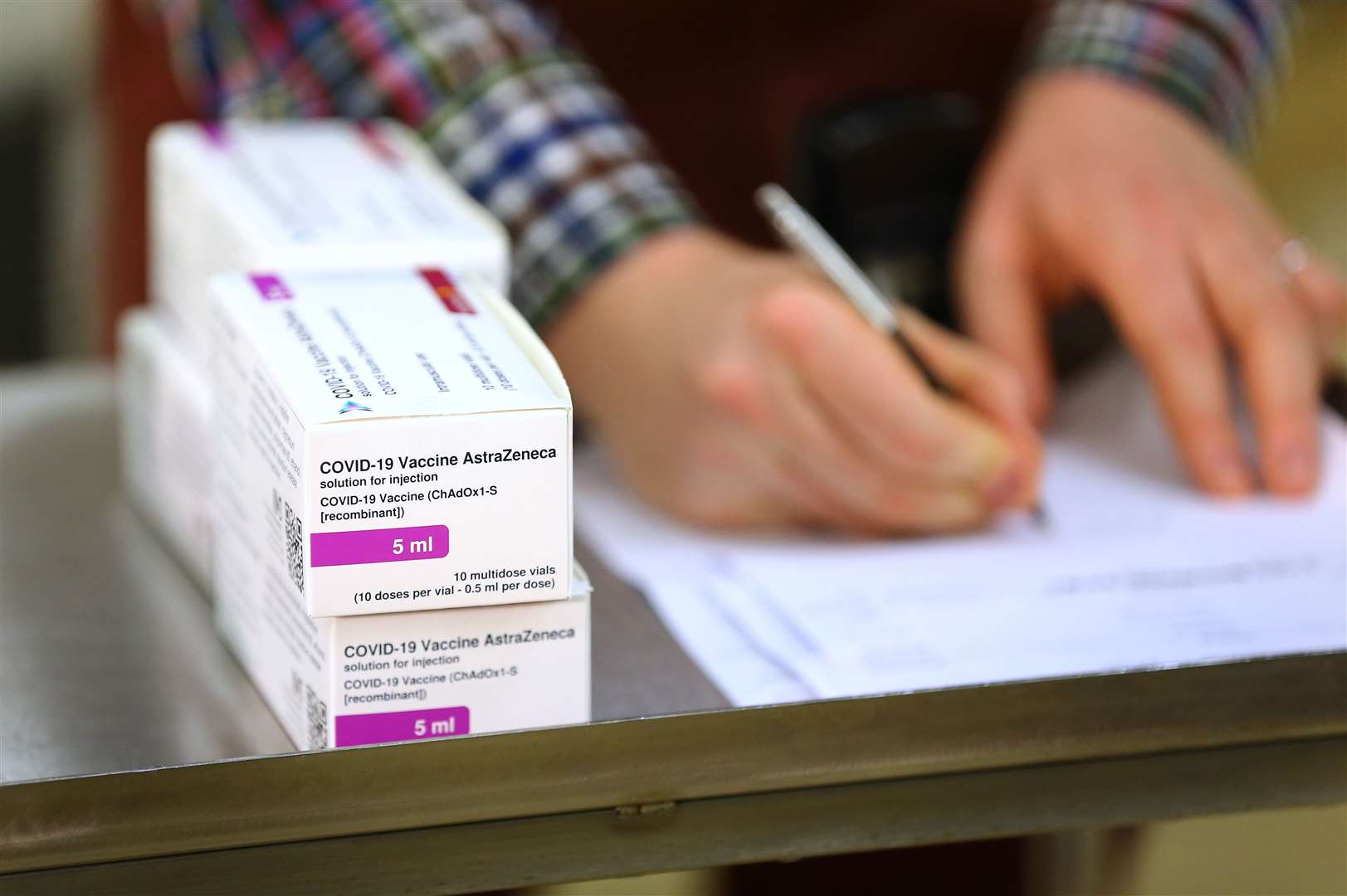 Doses of the Oxford University/AstraZeneca Covid-19 vaccine are logged by a technical officer (Gareth Fuller/PA)