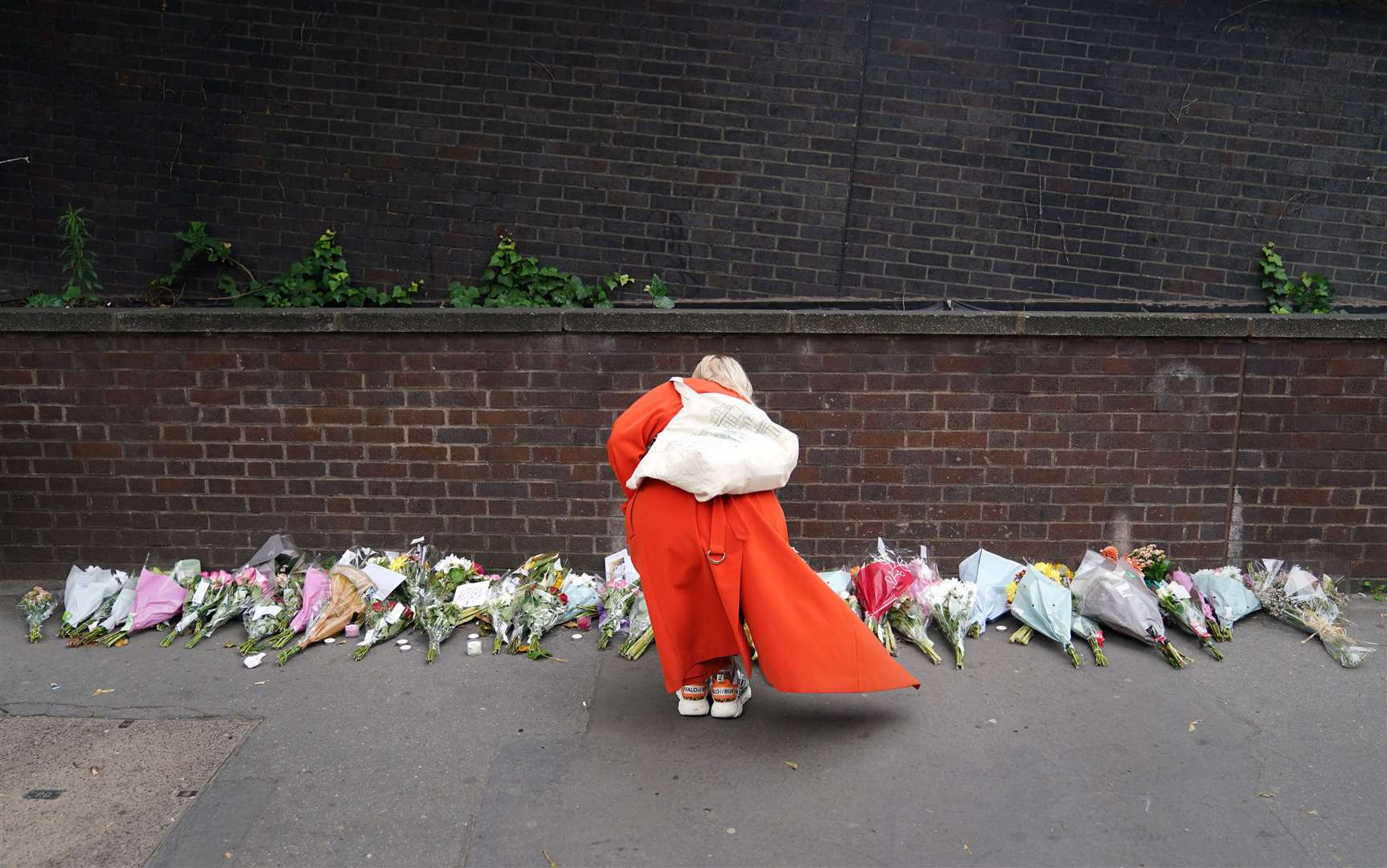 A woman lays flowers near the scene in Croydon (James Manning/PA)