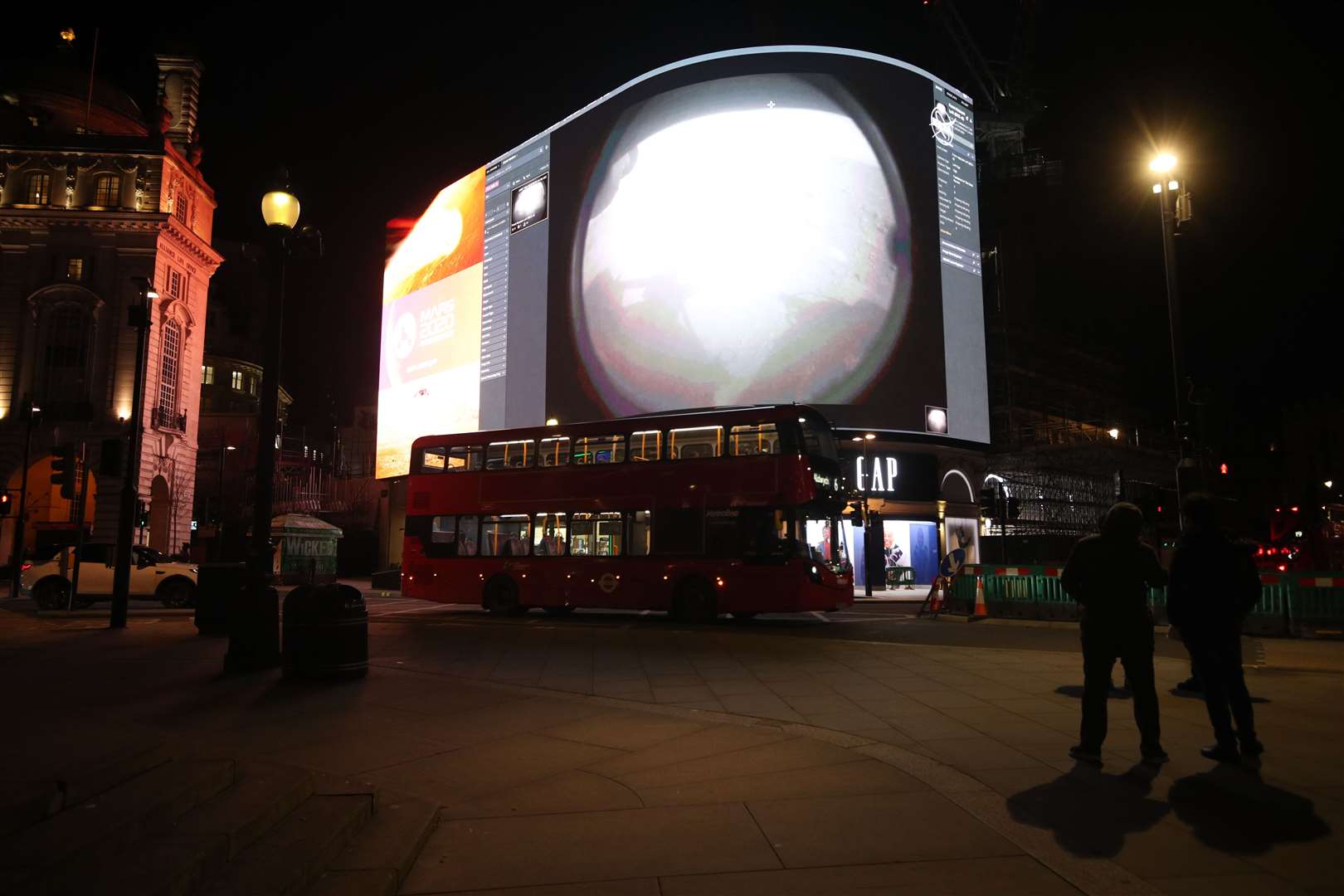 The landing being live streamed on Piccadilly Lights in central London (Yui Mok/PA)