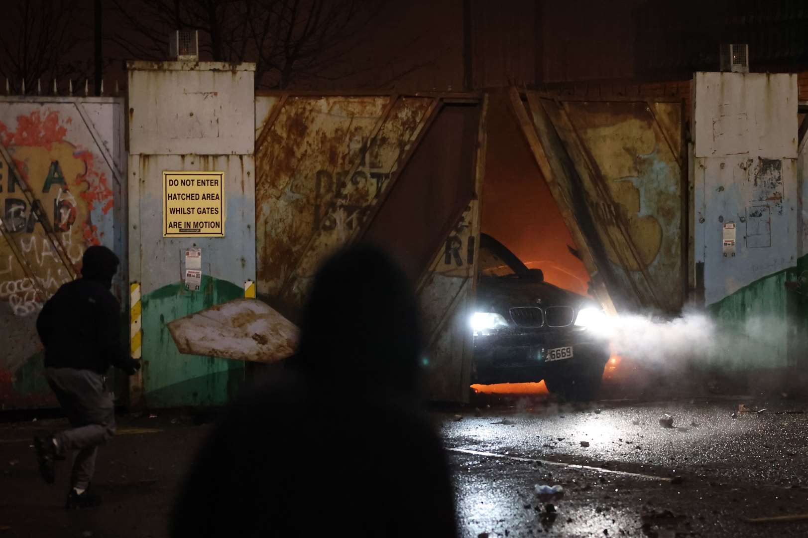 A car bursts through the Peace Gates in Lanark Way, Belfast, in April (Liam McBurney/PA)