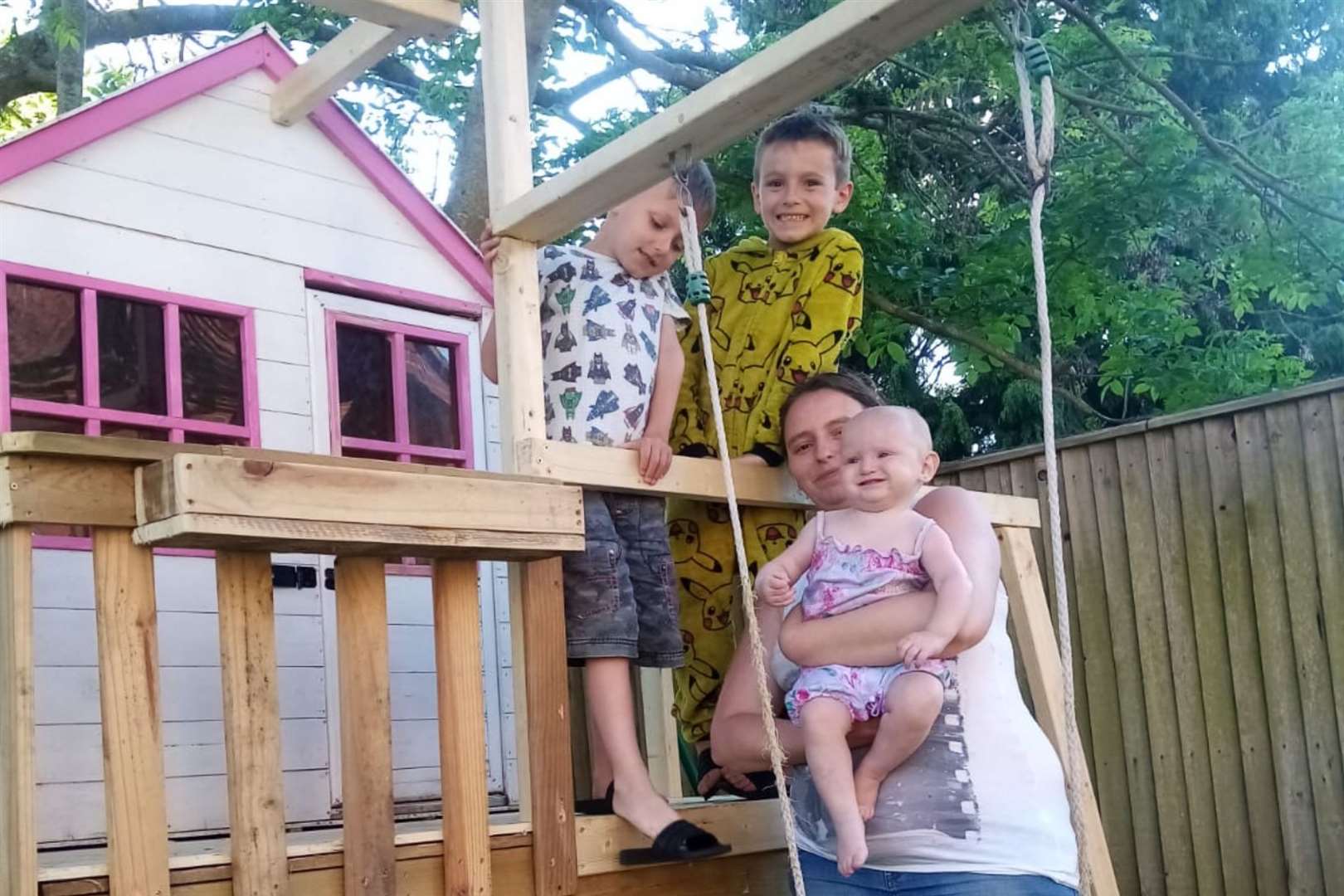 Cheryl and her children with the at-risk Wendy house