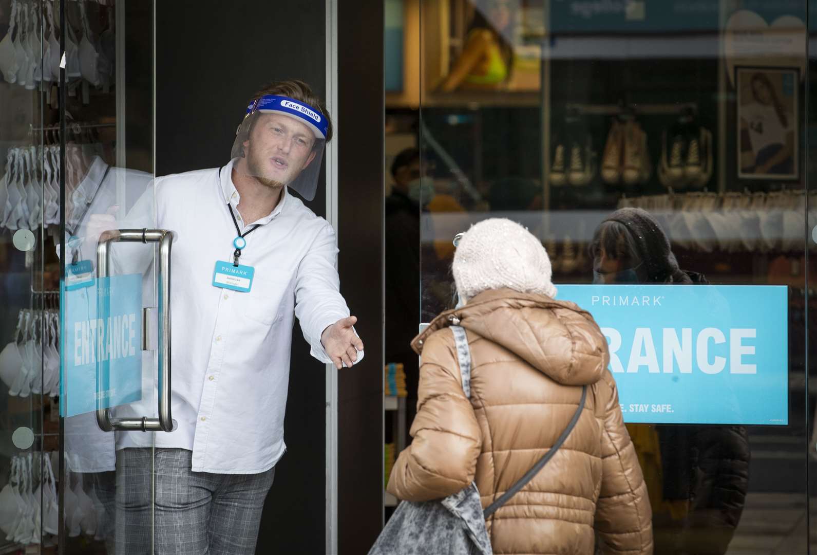 Members of staff at Primark on Princes Street in Edinburgh welcome customers after the store reopened (Jane Barlow/PA)