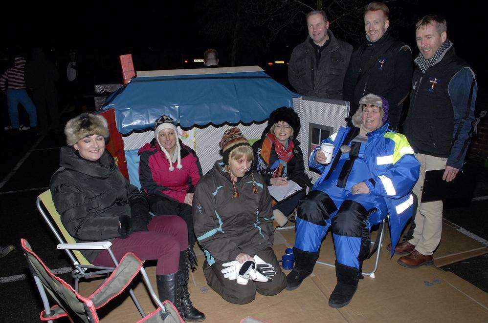 Members of Kent Autistic Trust in front of their cardboard house