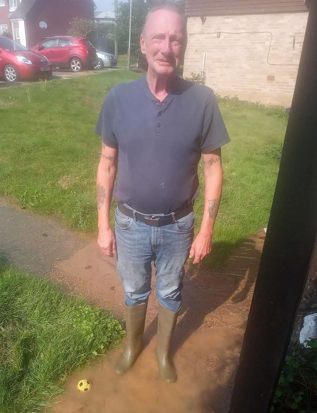 Richard Glass with his wellies on standing in the dirty water. Picture: Richard Glass