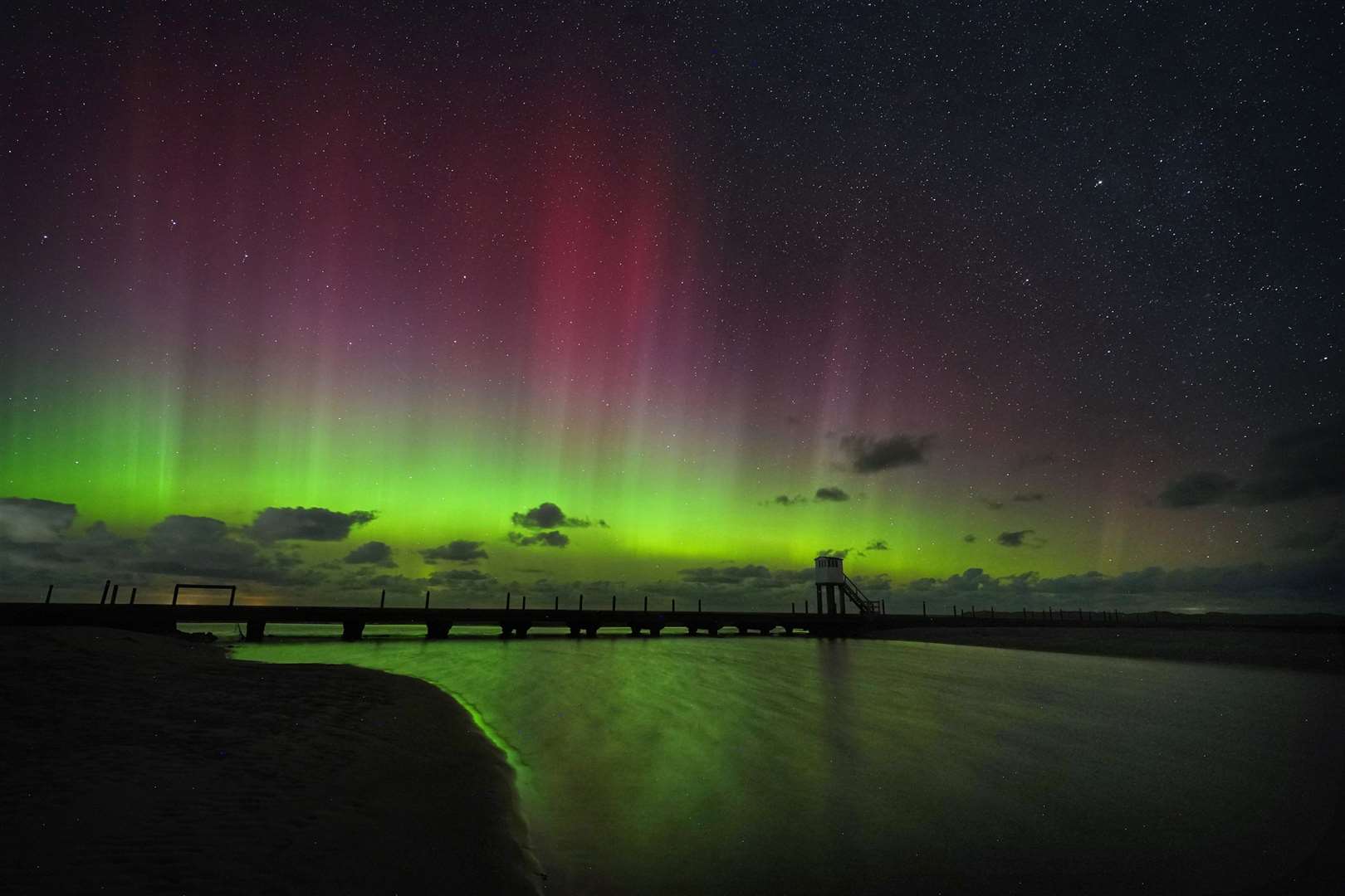 The Northern Lights over the refuge hut on the Holy Island causeway in Northumberland (Owen Humphreys/PA)