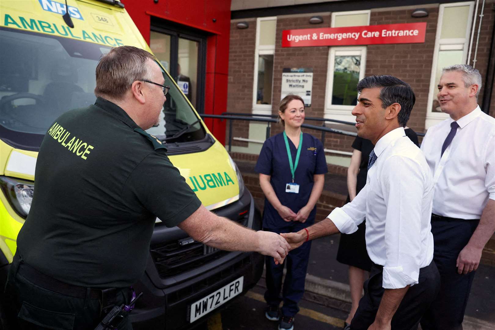 Mr Sunak with Secretary of State for Health Steve Barclay shaking hands with an ambulance staff member (Phil Noble/PA)