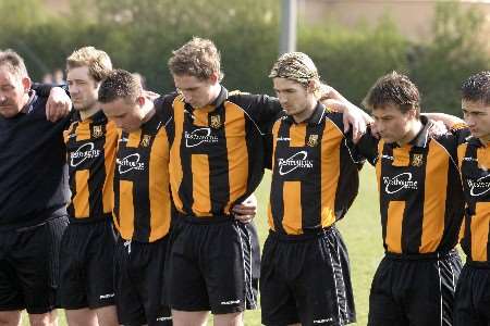 IN MEMORY: Players and staff of Folkestone Invicta observe a minute's silence for Paul Sykes. Picture: MARTIN APPS