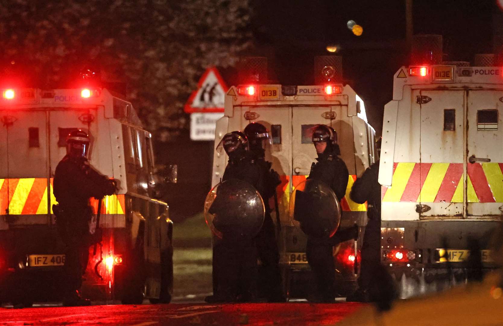 The PSNI on Northland in Carrickfergus near Belfast following sporadic outbursts of disorder (Liam McBurney/PA)