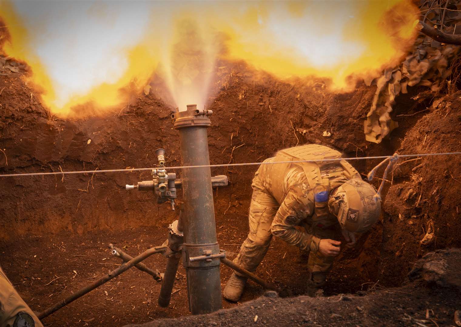 Ukrainian servicemen of the 28th Separate Mechanised Brigade fires a 122mm mortar towards Russian positions at the front line, near Bakhmut, Donetsk (AP)