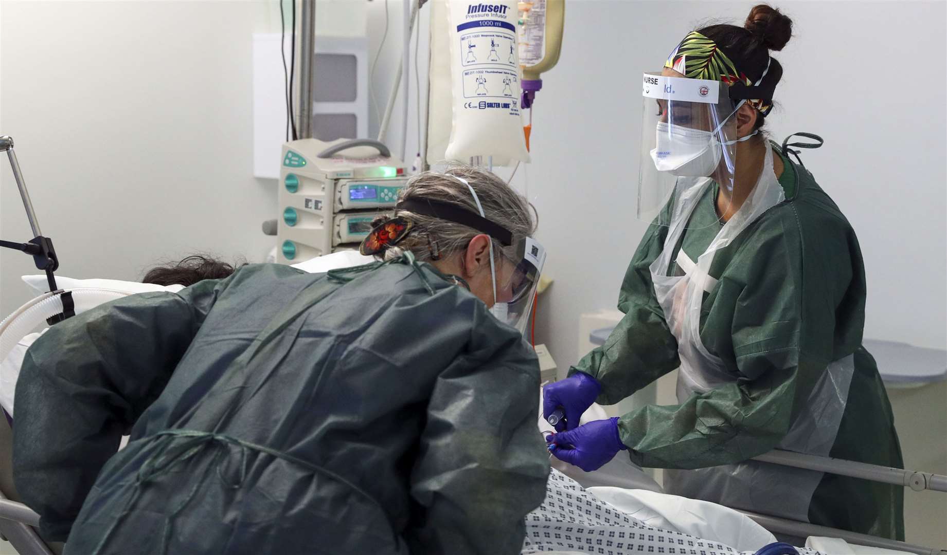 Nurses caring for a patient in an intensive care ward (Steve Parsons/PA)