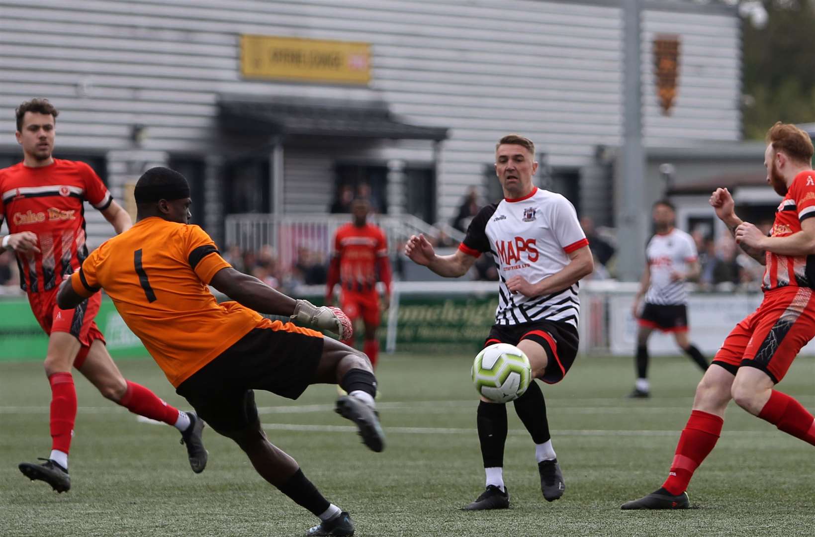 Punjab goalkeeper Rilwan Anibaba clears ahead of Deal's Tom Chapman. Picture: Paul Willmott