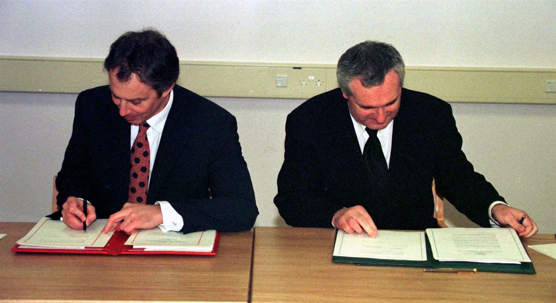 Tony Blair and Bertie Ahern sign the peace agreement in 1998 (Dan Chung/PA)