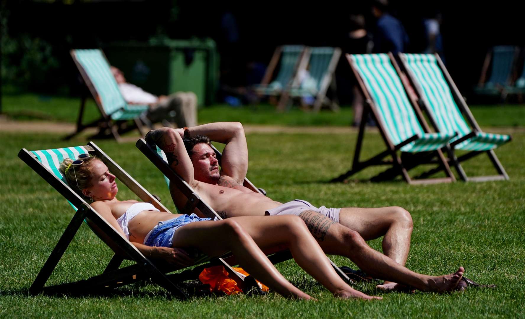 Sunbathers lounge in Green Park near Buckingham Palace (Jonathan Brady/PA)