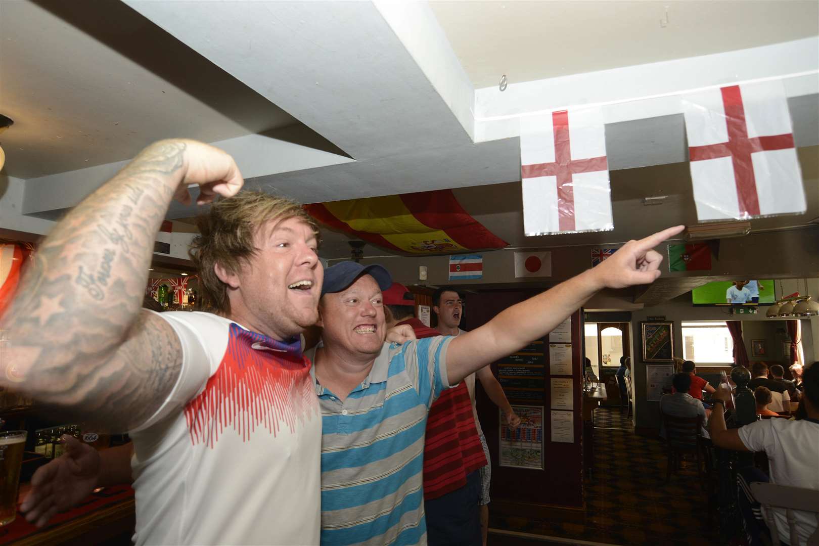 Robbie Delaney and Paul Berry cheer England's third goal at John Wallis.Picture: Paul Amos