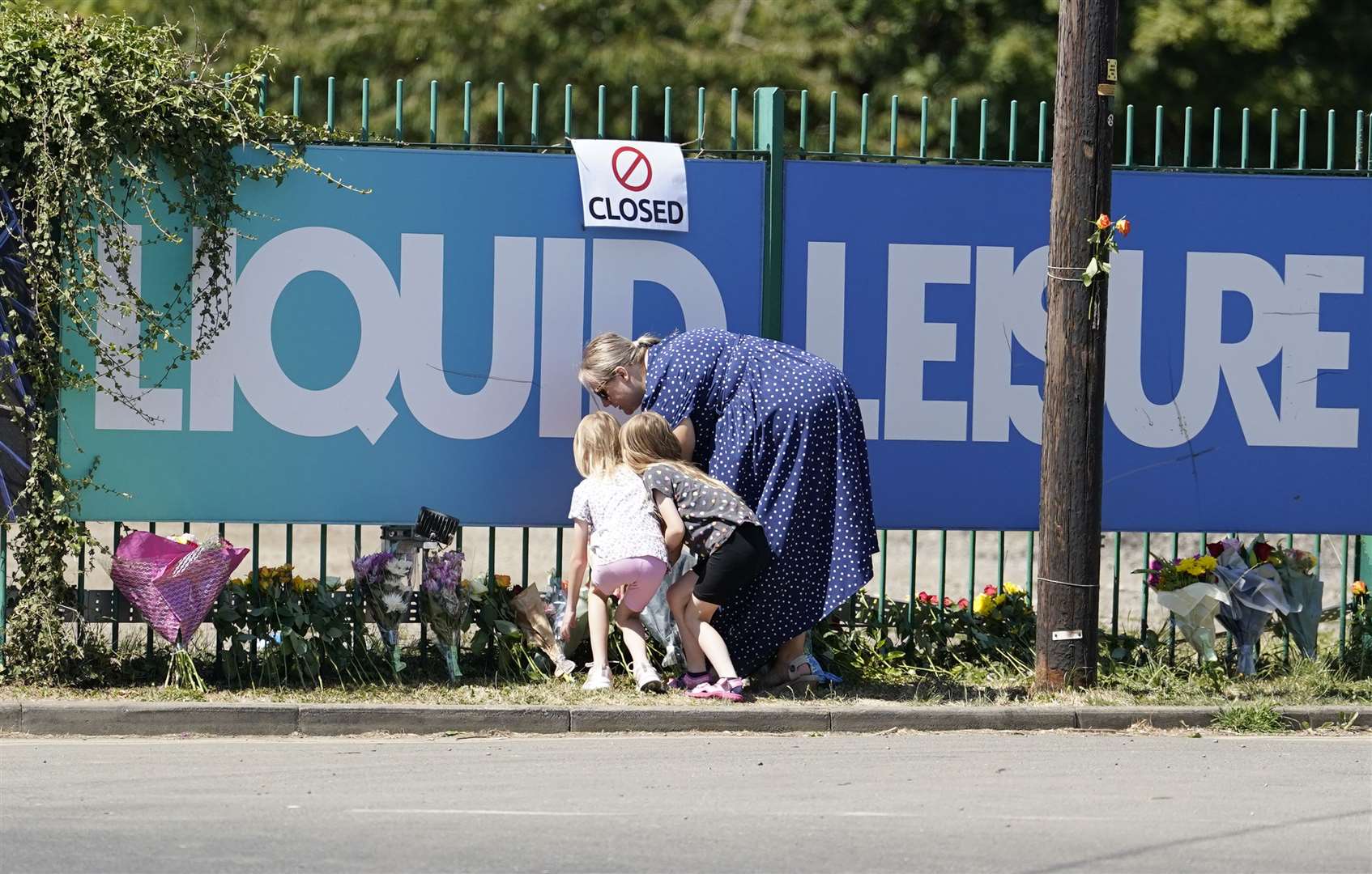 People leave flowers outside Liquid Leisure in Windsor. (PA)