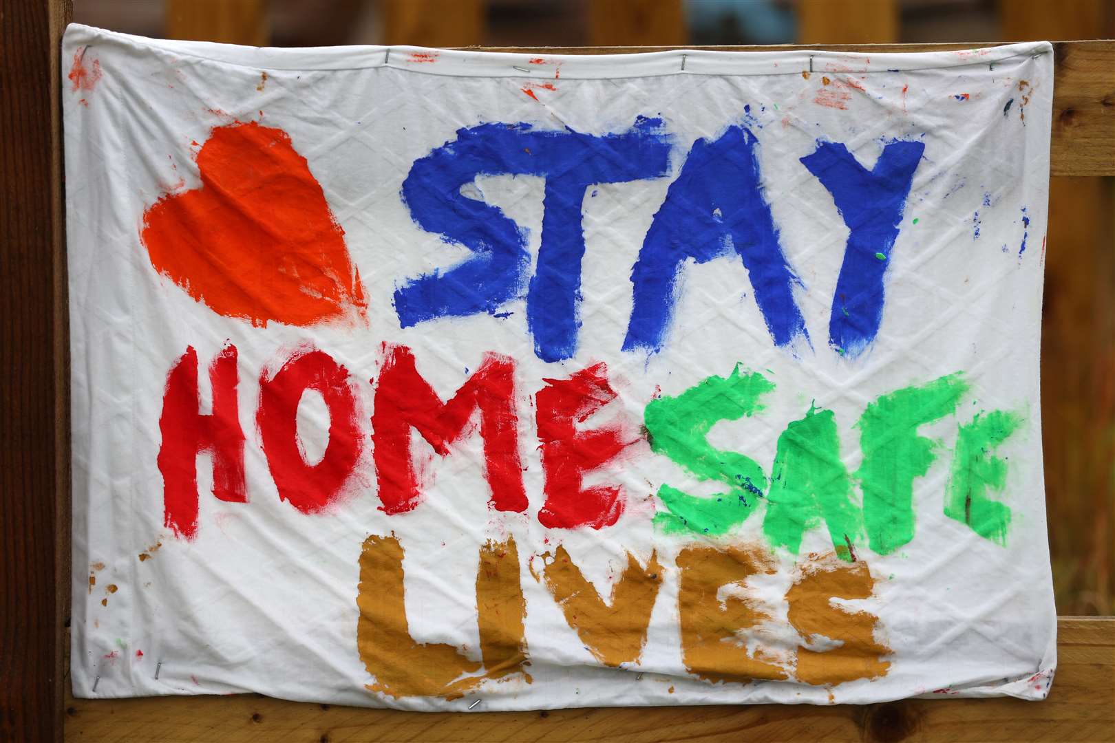 A homemade banner saying ‘Stay Home, Save Lives’ is hung outside The Dragonfly pub in Basingstoke (Andrew Matthews/PA)