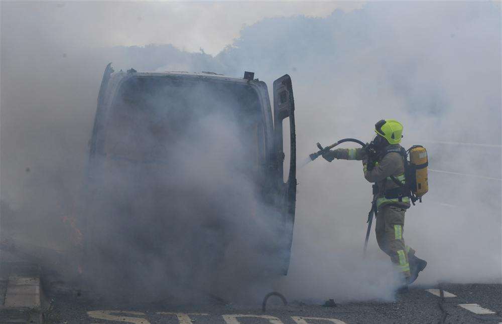 A firefighter tackles the blaze.