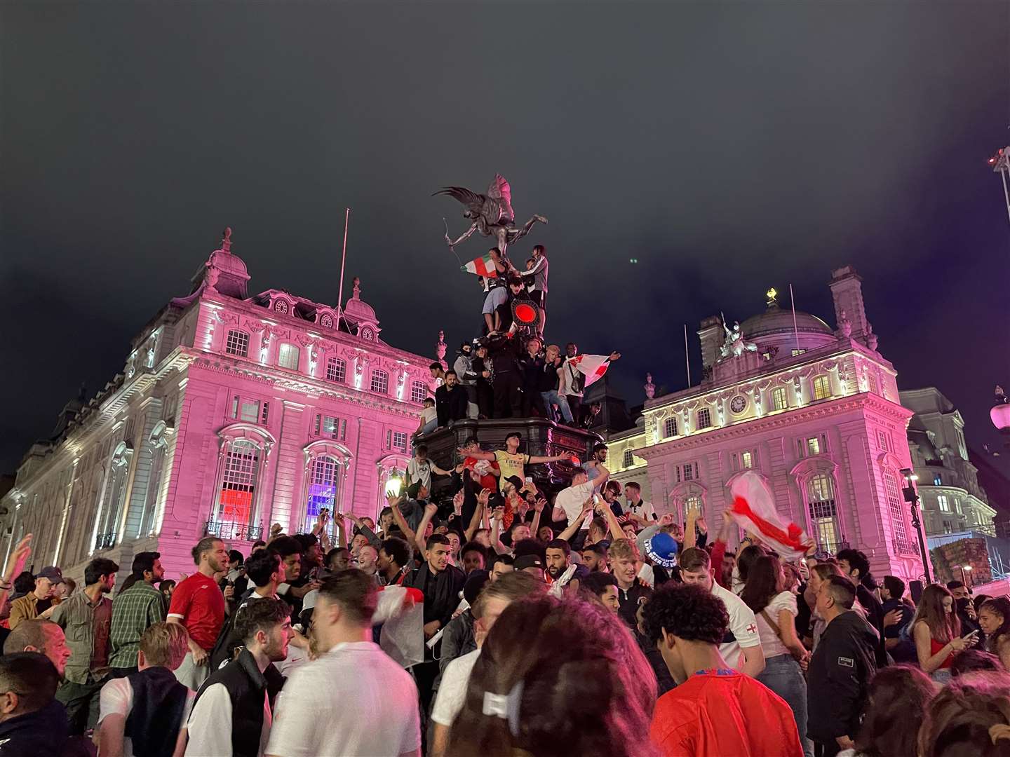 England football fans climb the statue of Eros in Piccadilly Circus, central London (Isobel Frodsham/PA)