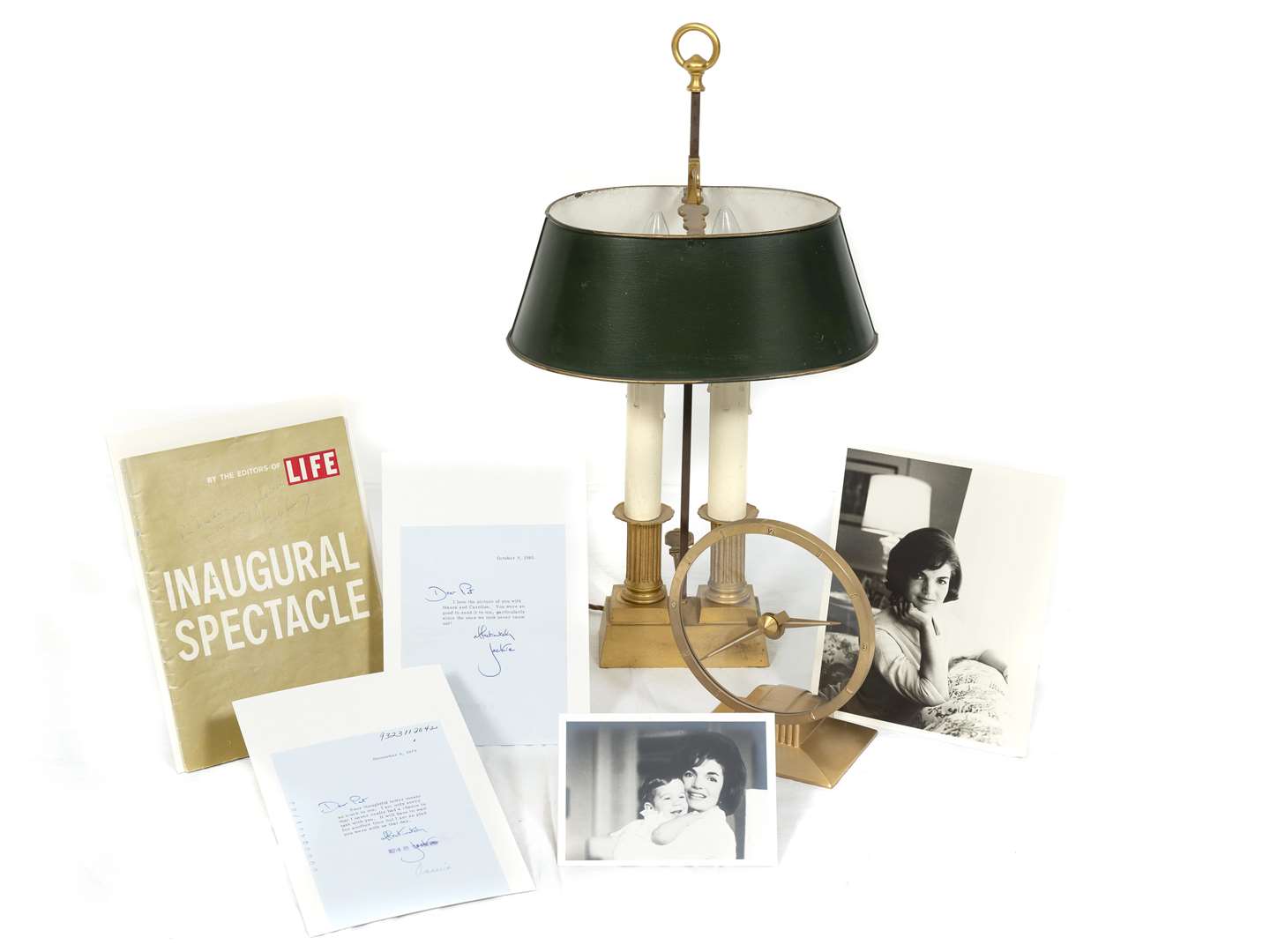 The collection includes a Louis XVI-style bronze twin-light bouillotte lamp, which was in the White House during the presidential term of John F Kennedy, and letters from Jackie Kennedy (Robert Malone/PA)