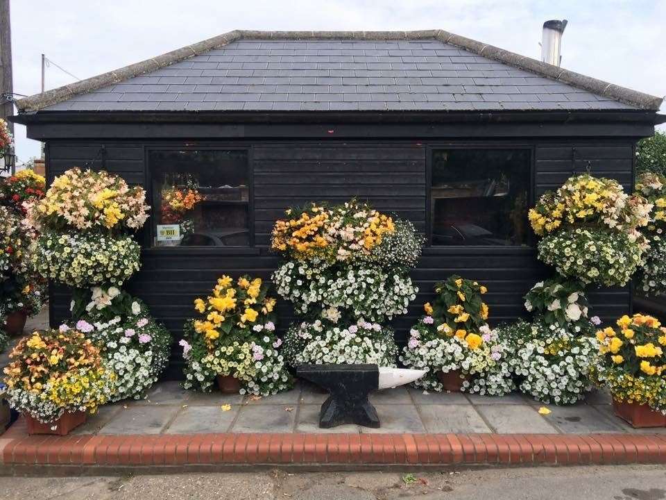 The pub garden features a patio area with plants