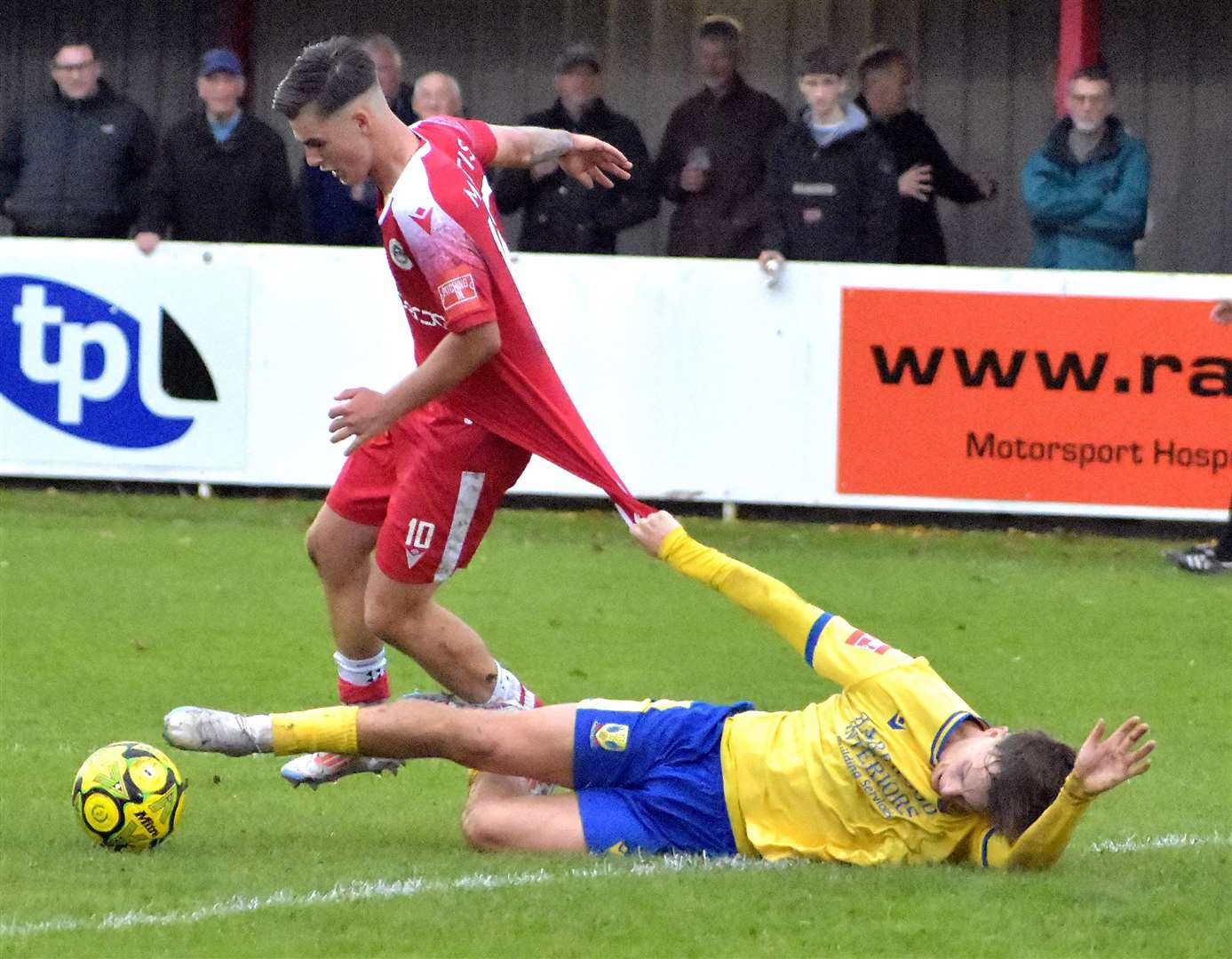 Opening goalscorer Riley Court is pulled back by a Lancing defender. Picture: Randolph File