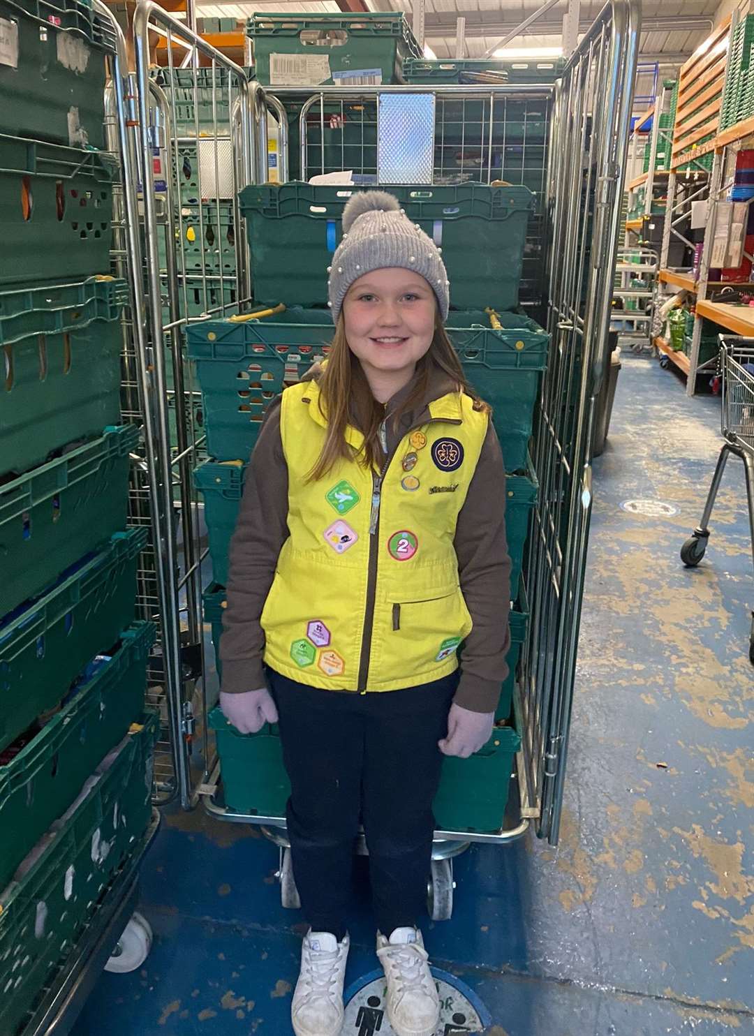 Young Brownie Rose donating food to Medway Foodbank